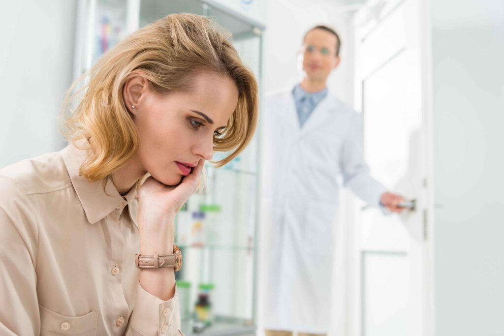 Woman experiencing tooth pain at a dental clinic.